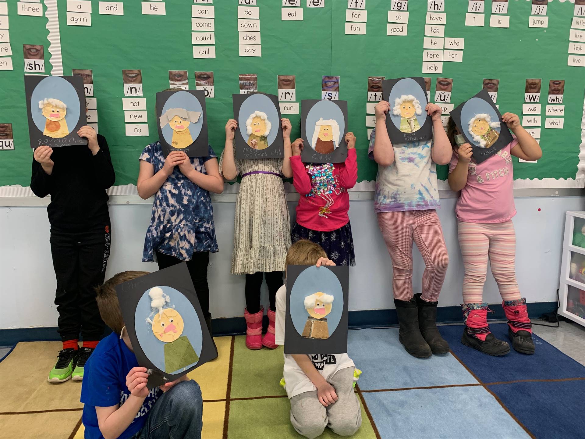 a group of students with their 100 year old self portraits