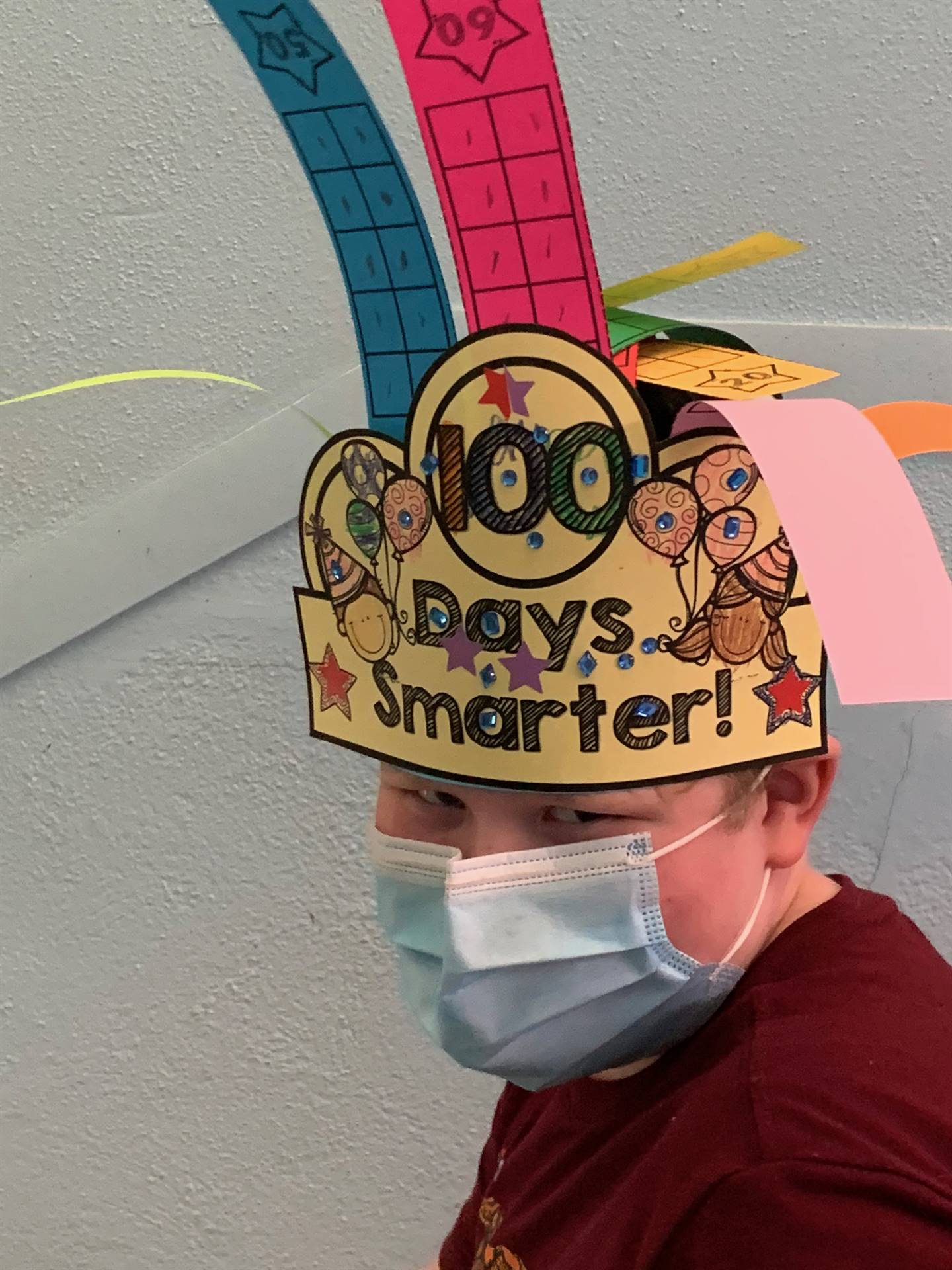 student with 100 days smarter hat.