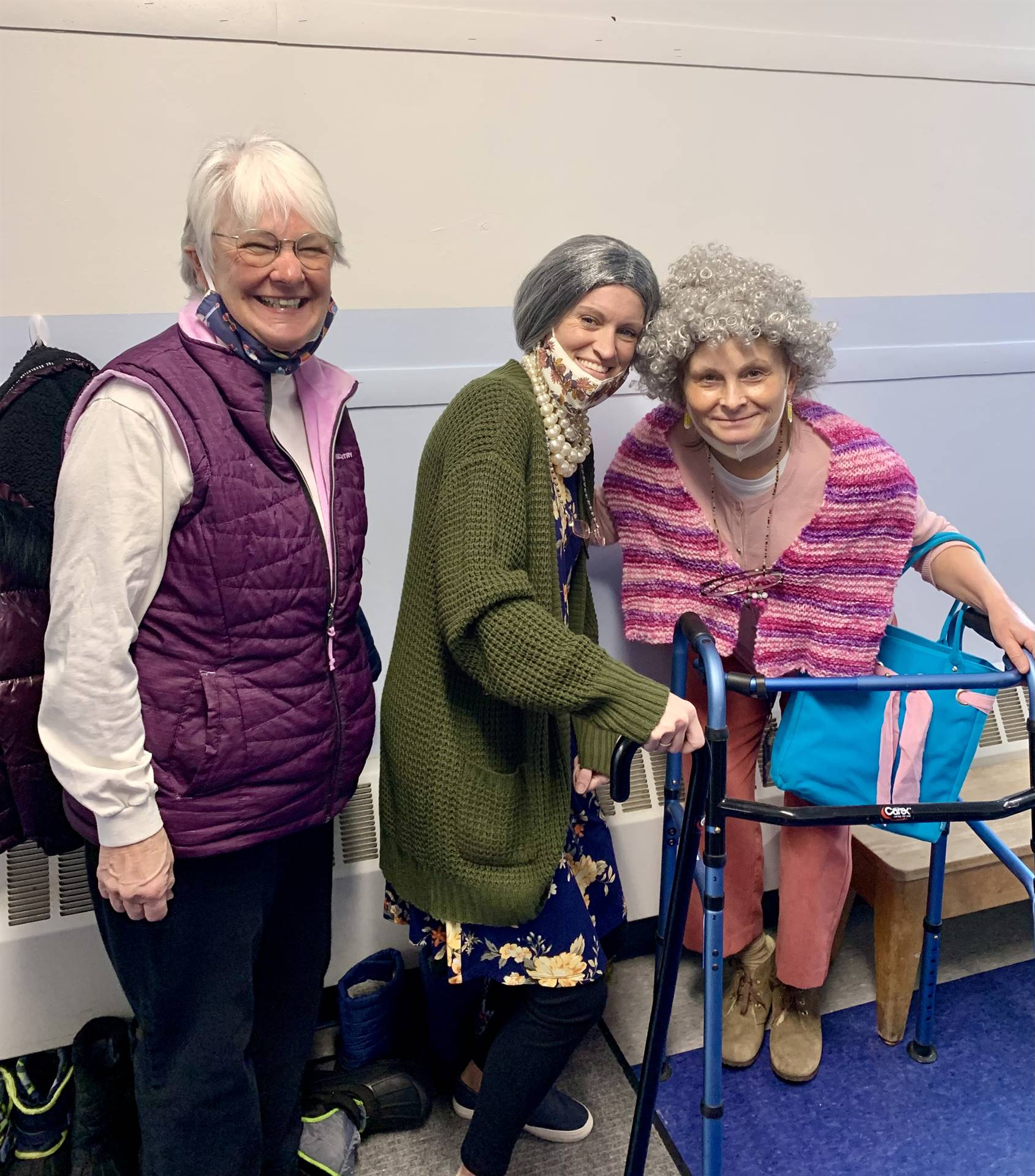 3 older ladies with canes and a walker