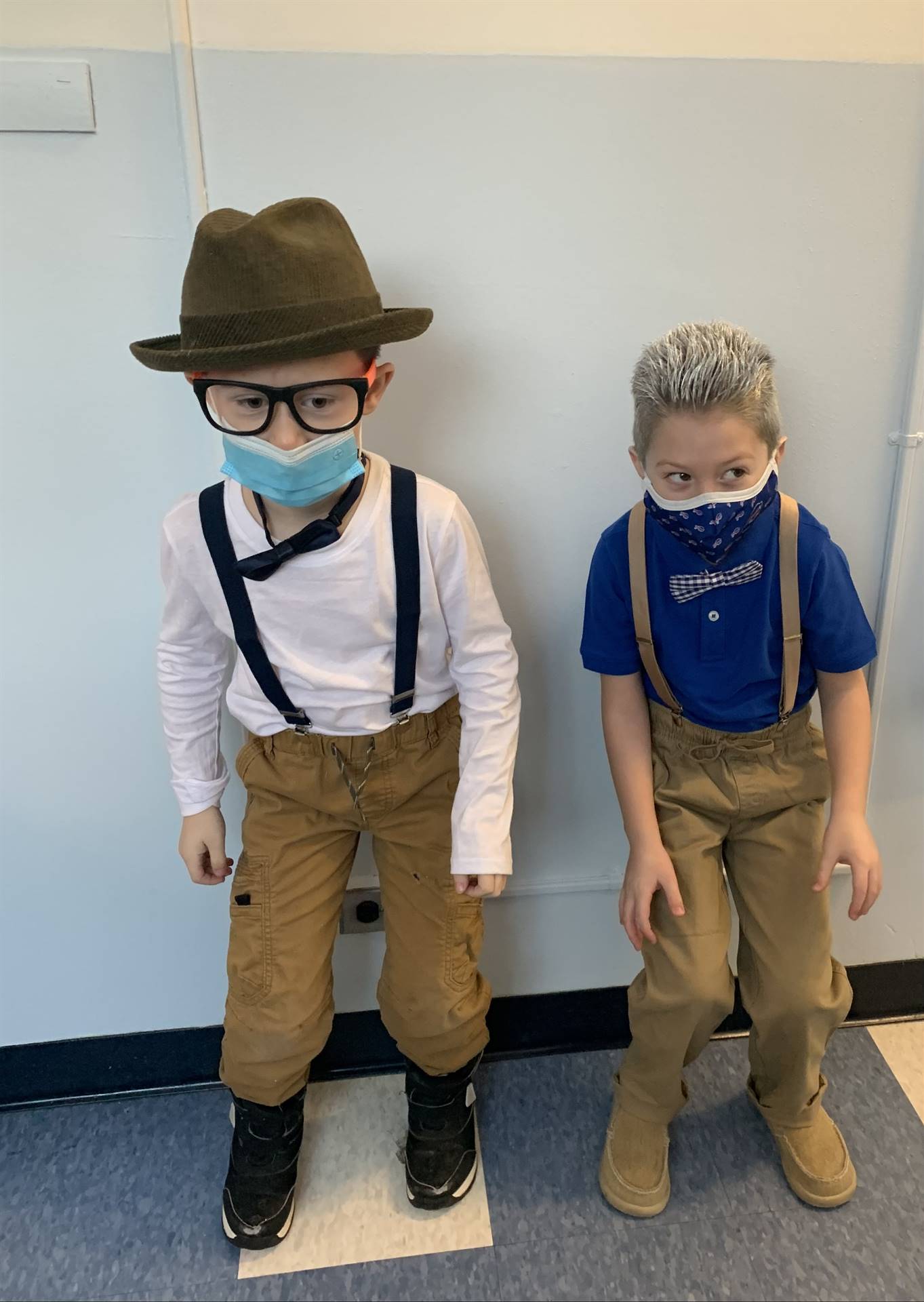 2 boys with suspenders and a hat