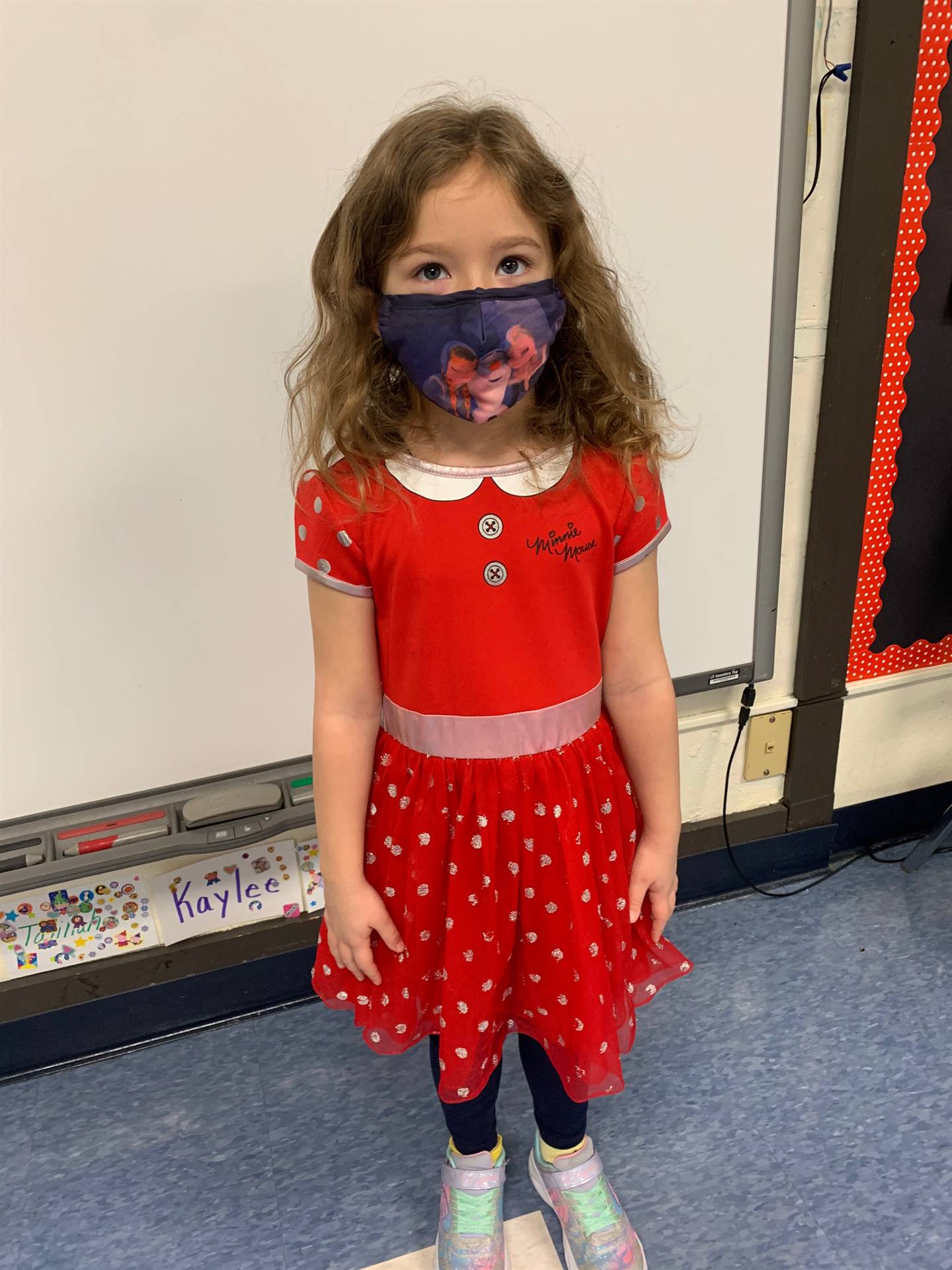student in red dress and mask