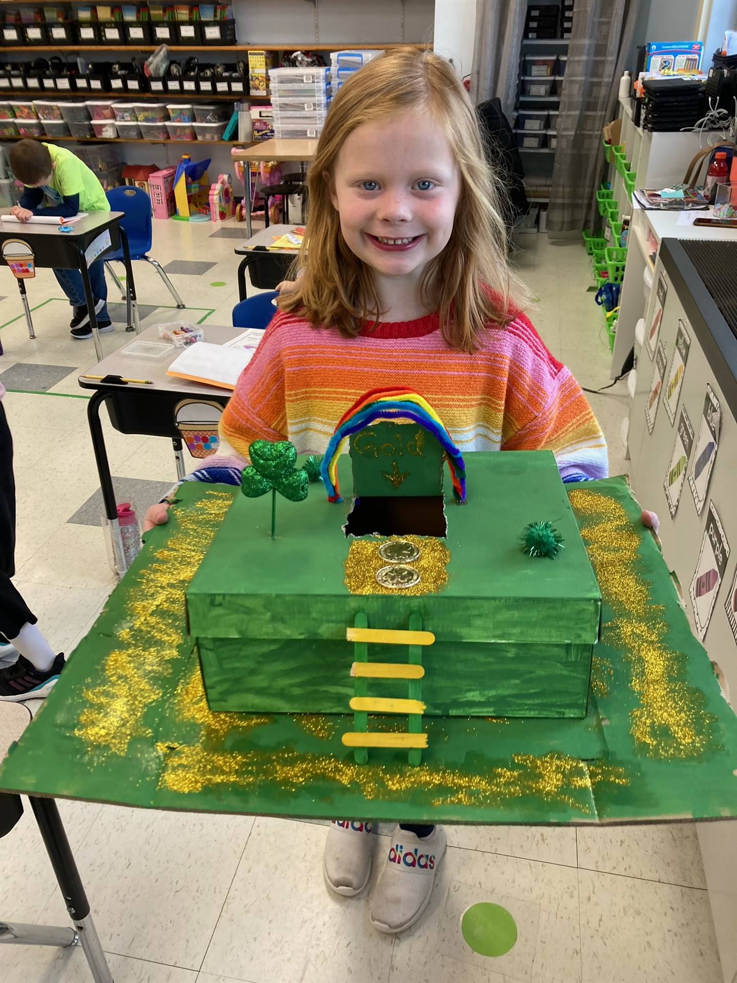 student with green and gold leprechaun trap