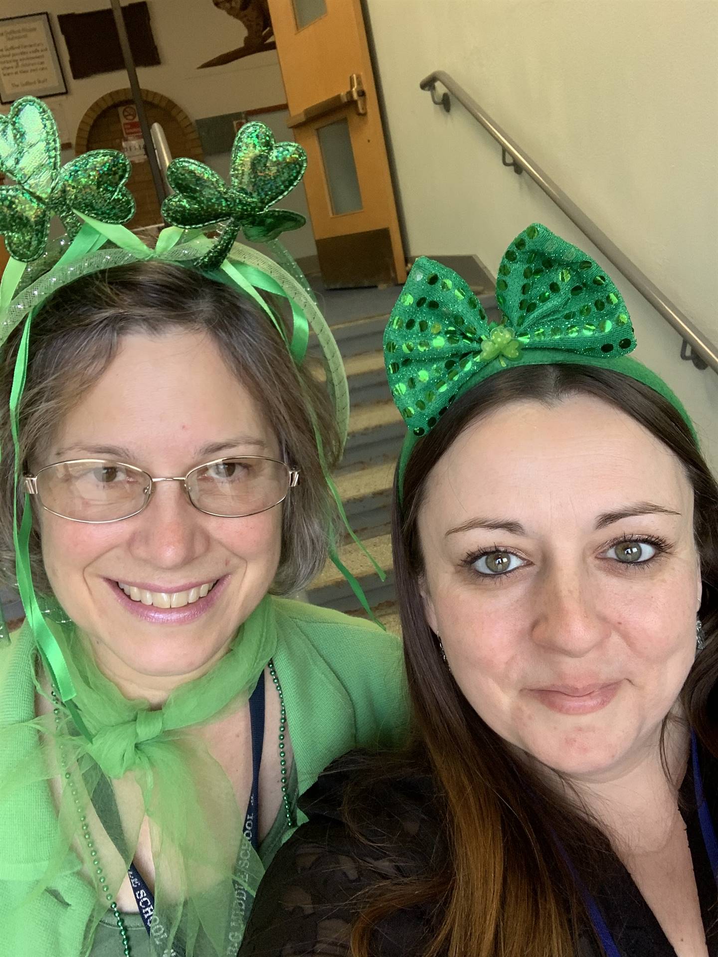 2 staff members with green headbands.