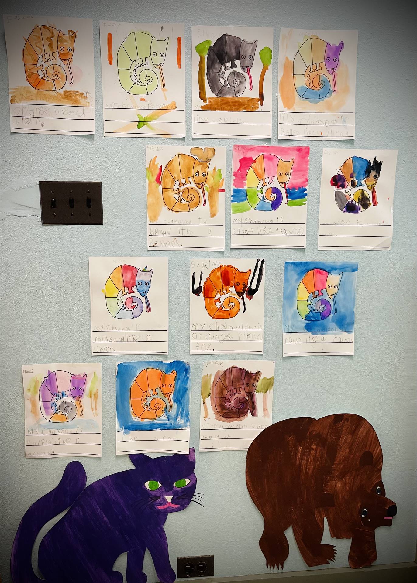 a wall with a blue cat and brown bear and colorful artwork