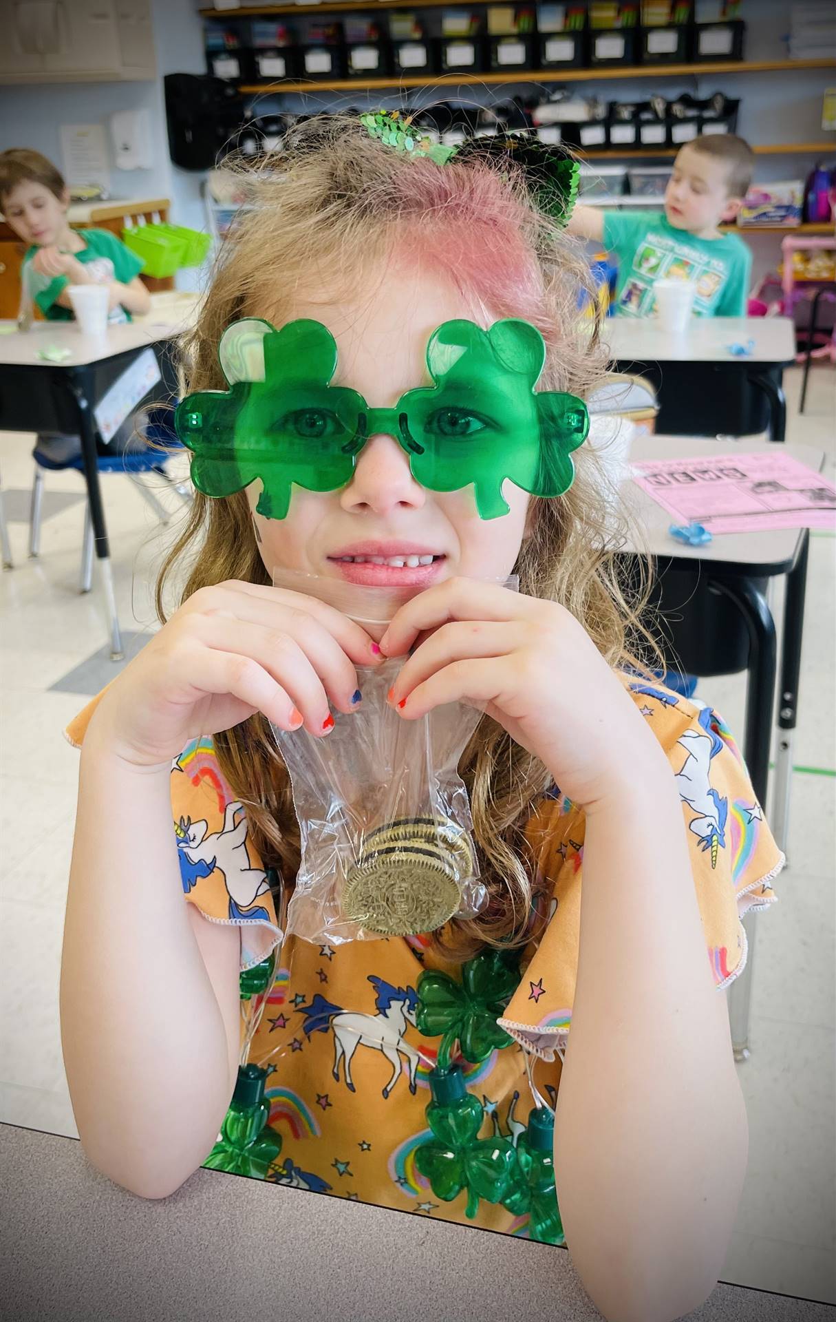 a student with green shamrock glasses