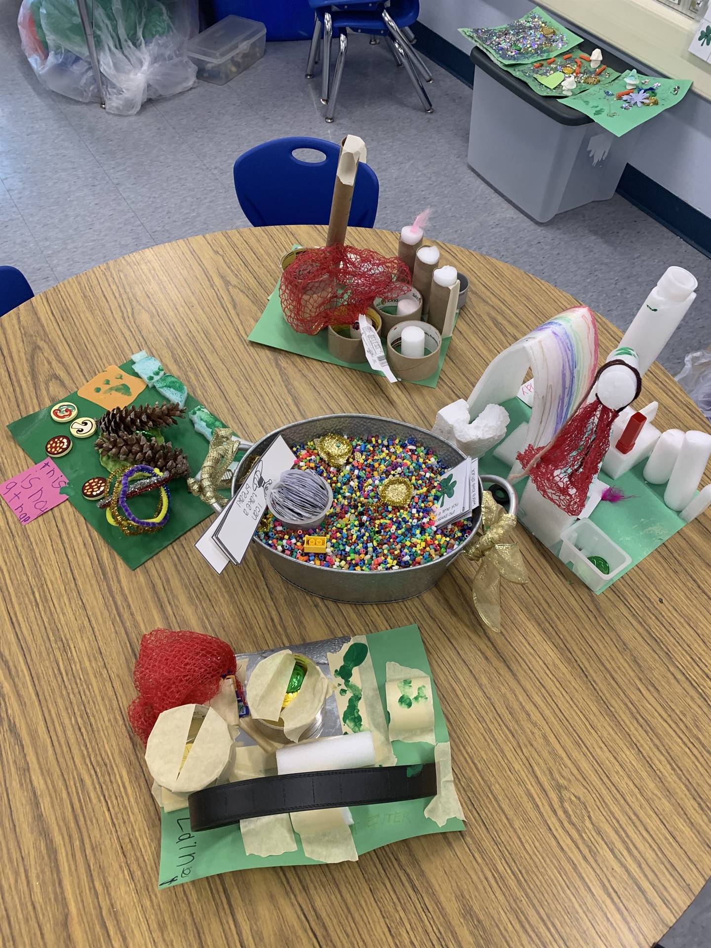 4 leprechaun traps with a rainbow bead bin in middle