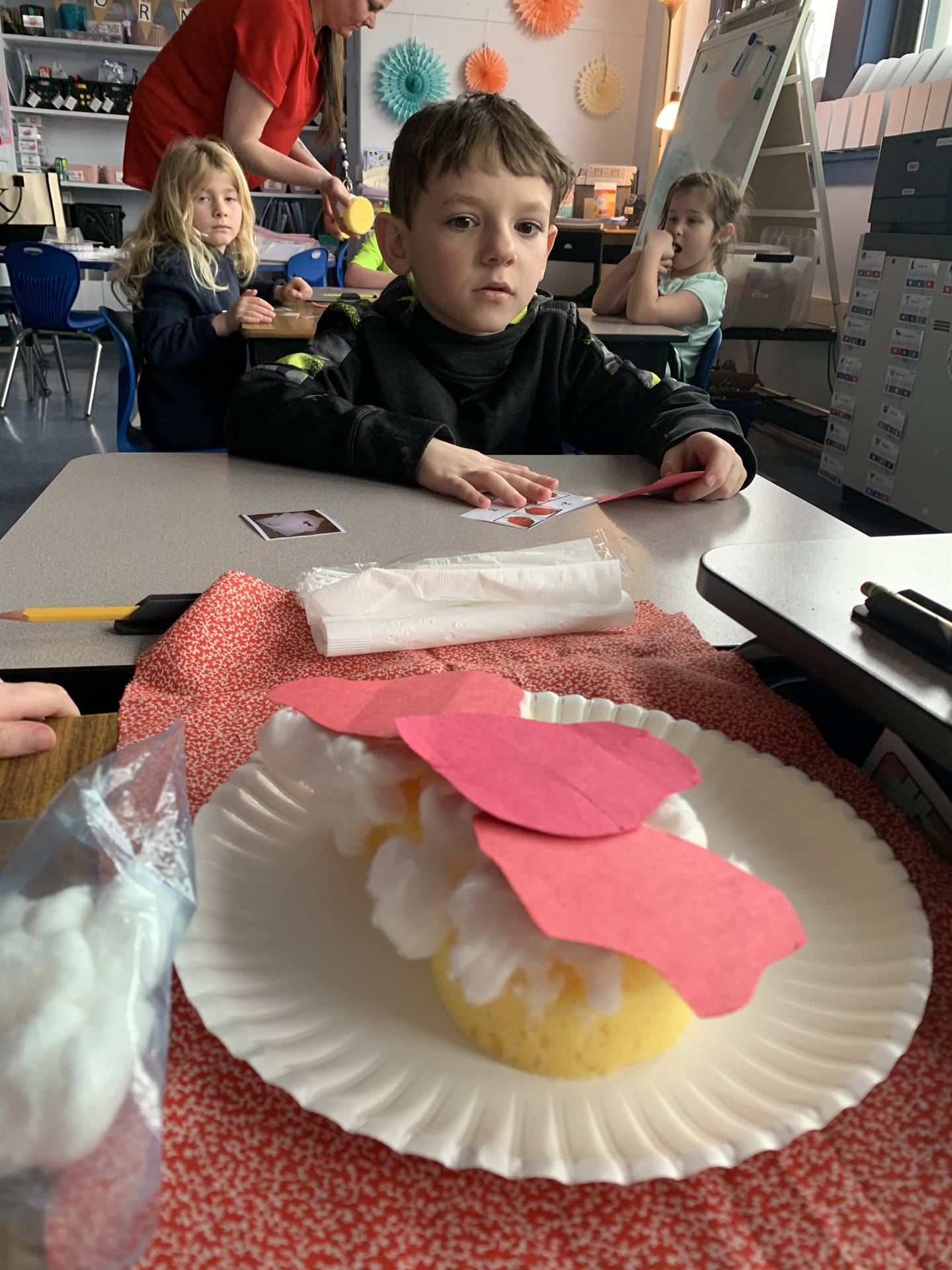 student works to assemble a strawberry shortcake