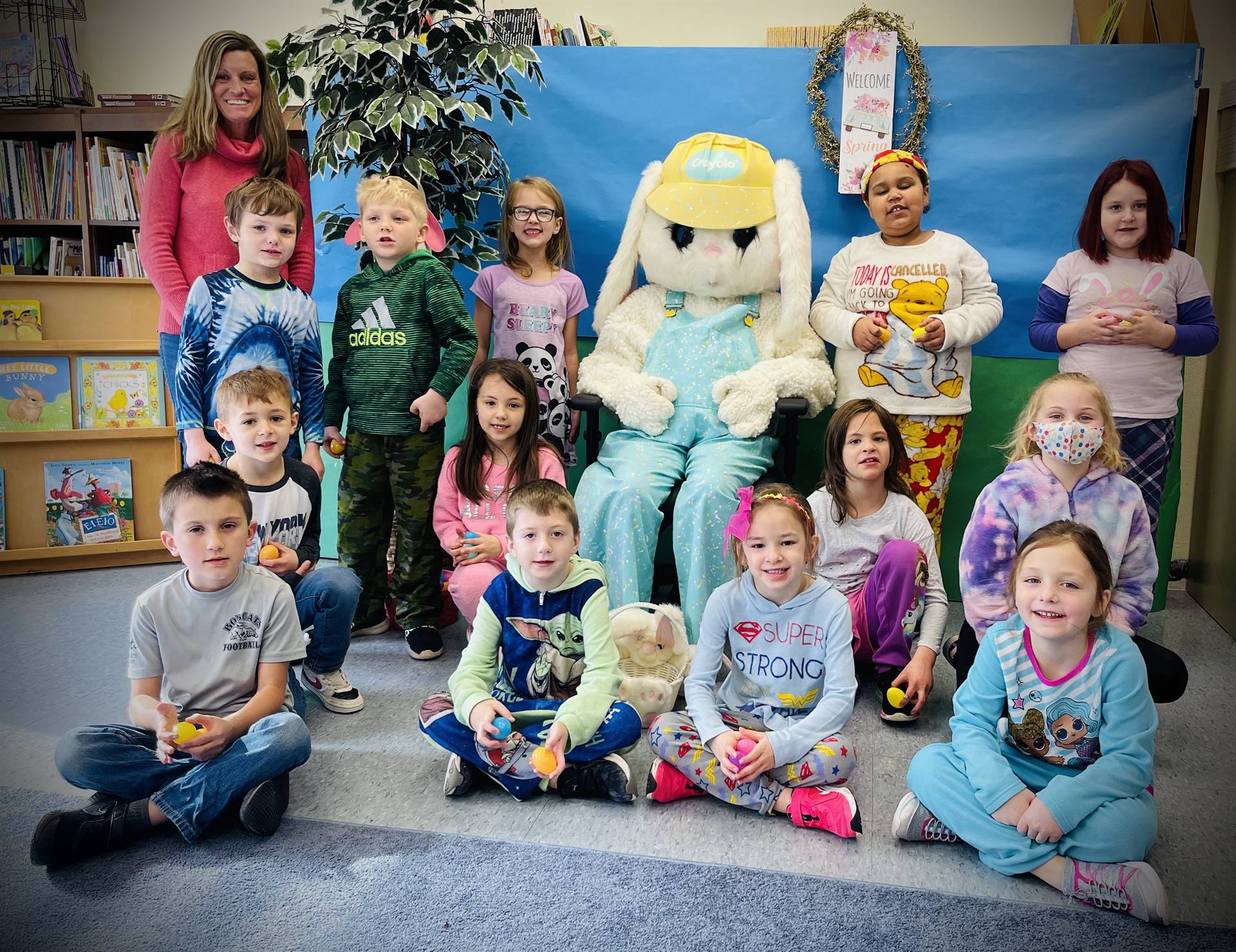 a group of students with adult dressed as a bunny in middle.