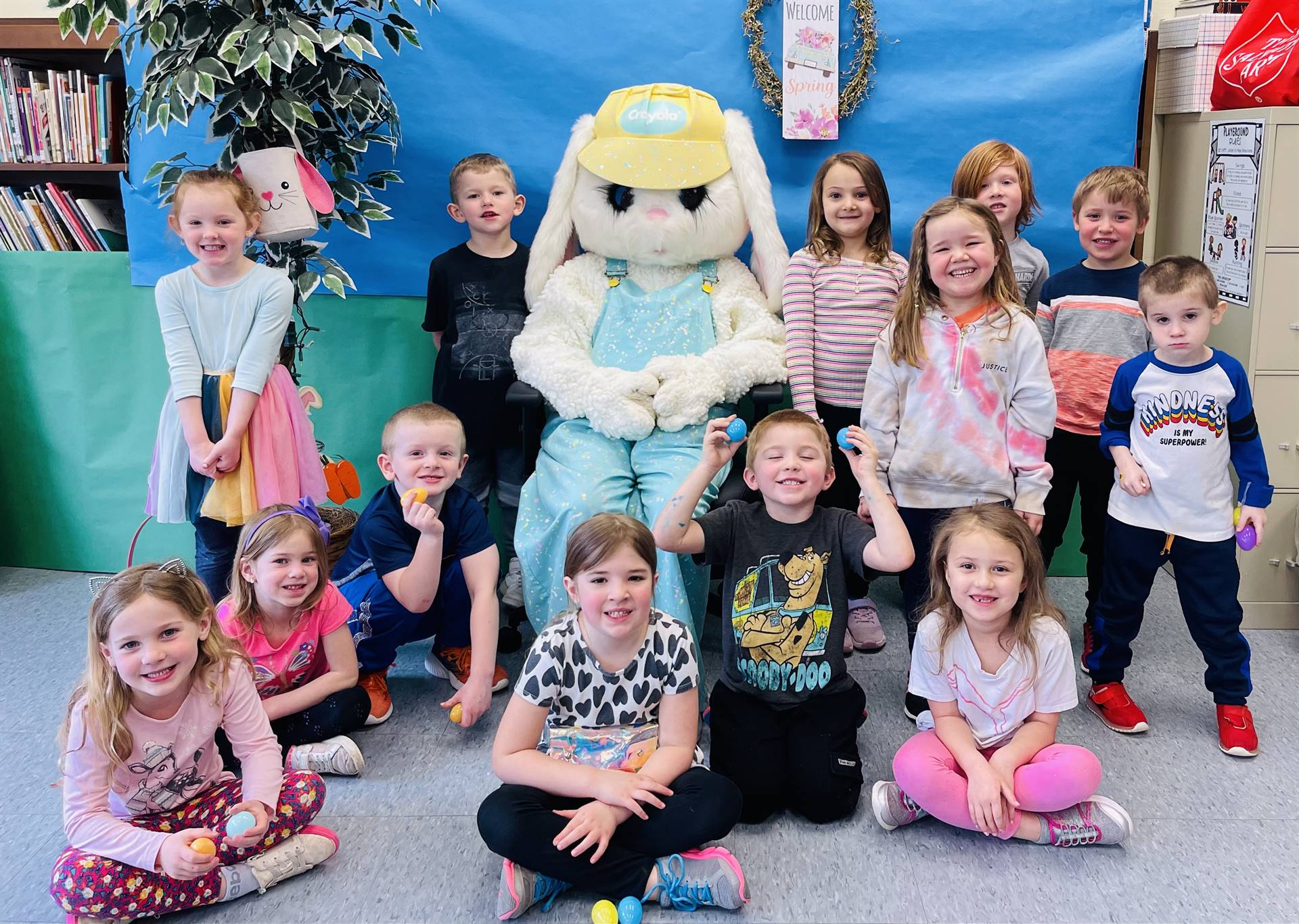 a group of students with adult dressed as a bunny in middle.