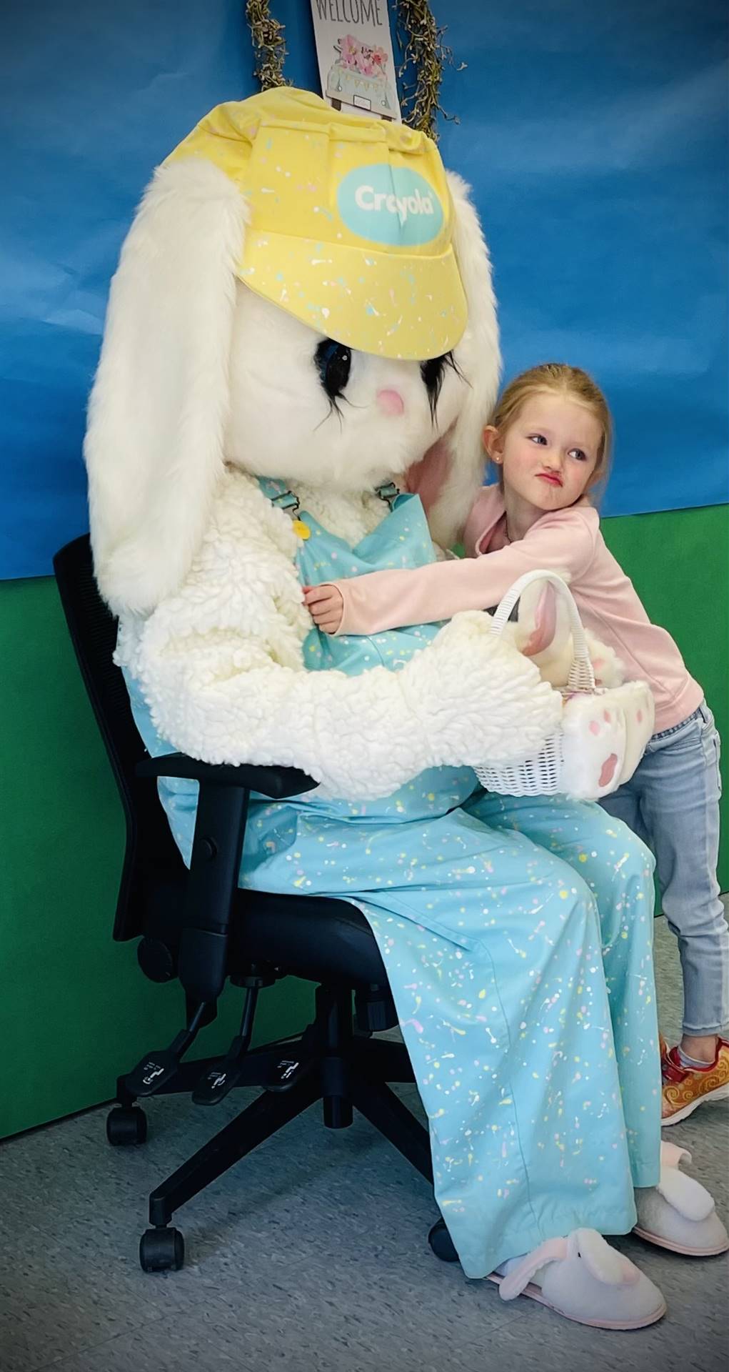 a student hugs adult dressed as spring bunny.