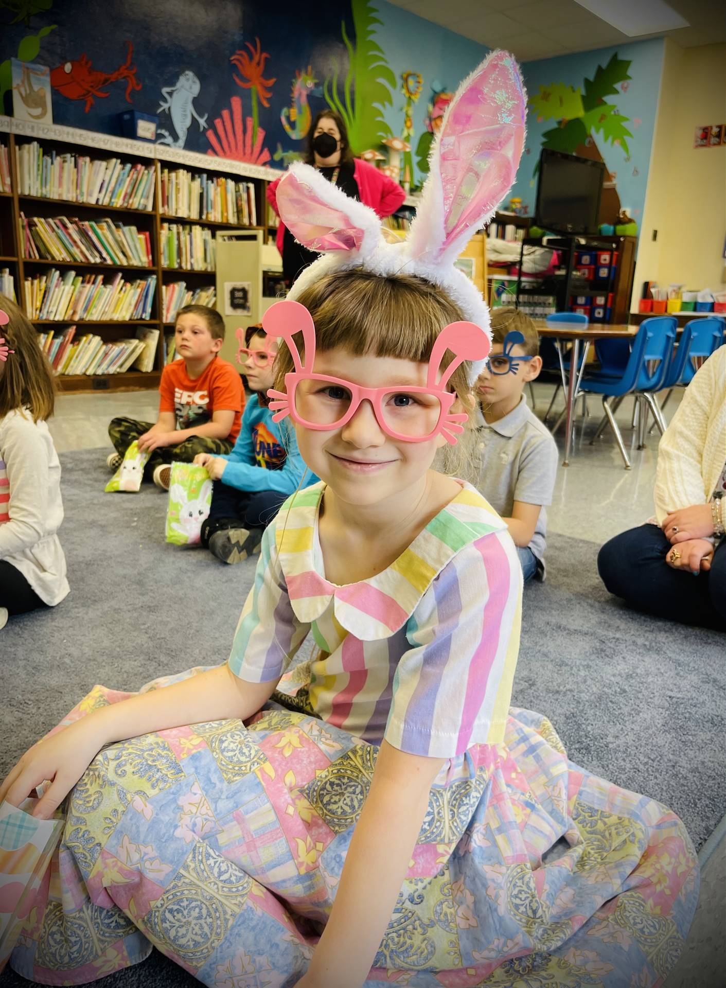 a student with pink bunny glasses and pink bunny ears.