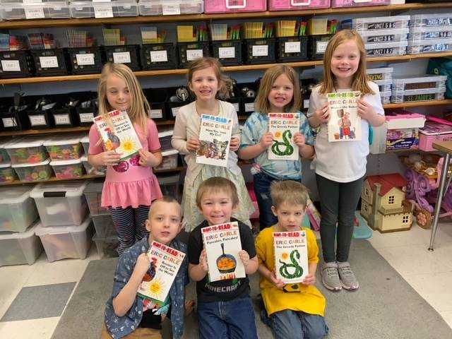 7 students holding books they won for Read across america