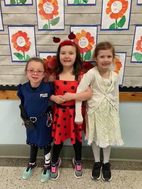 3 students dressed in character.