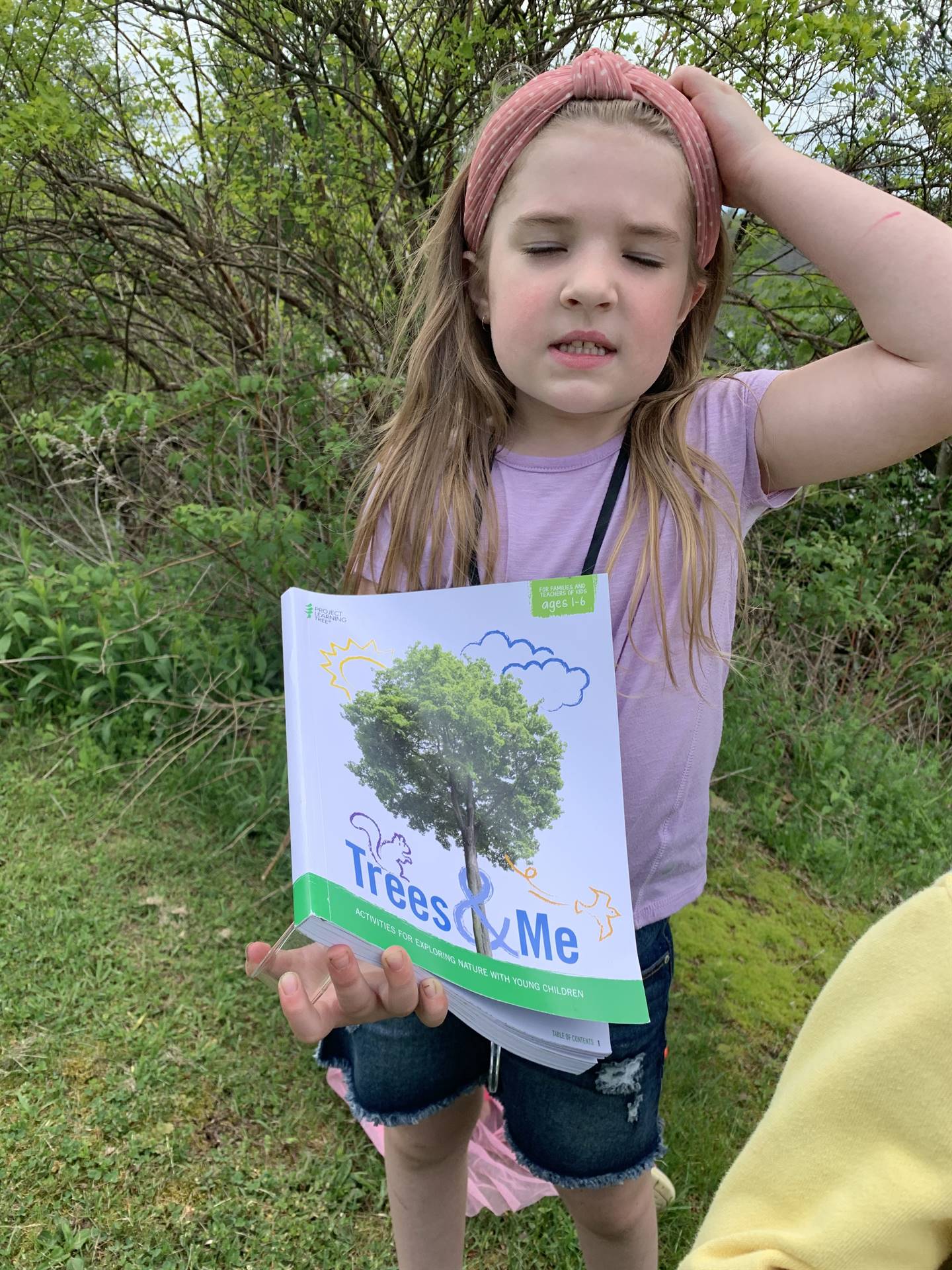 child showing a nature book