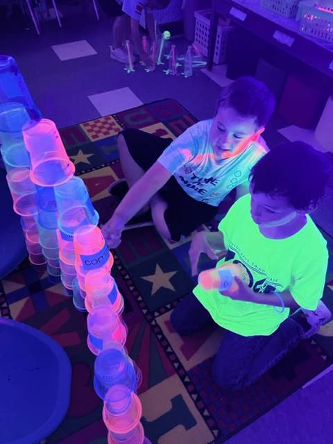 students building with cups for glow day