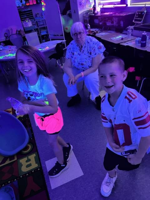 students smiling and glowing for glow day
