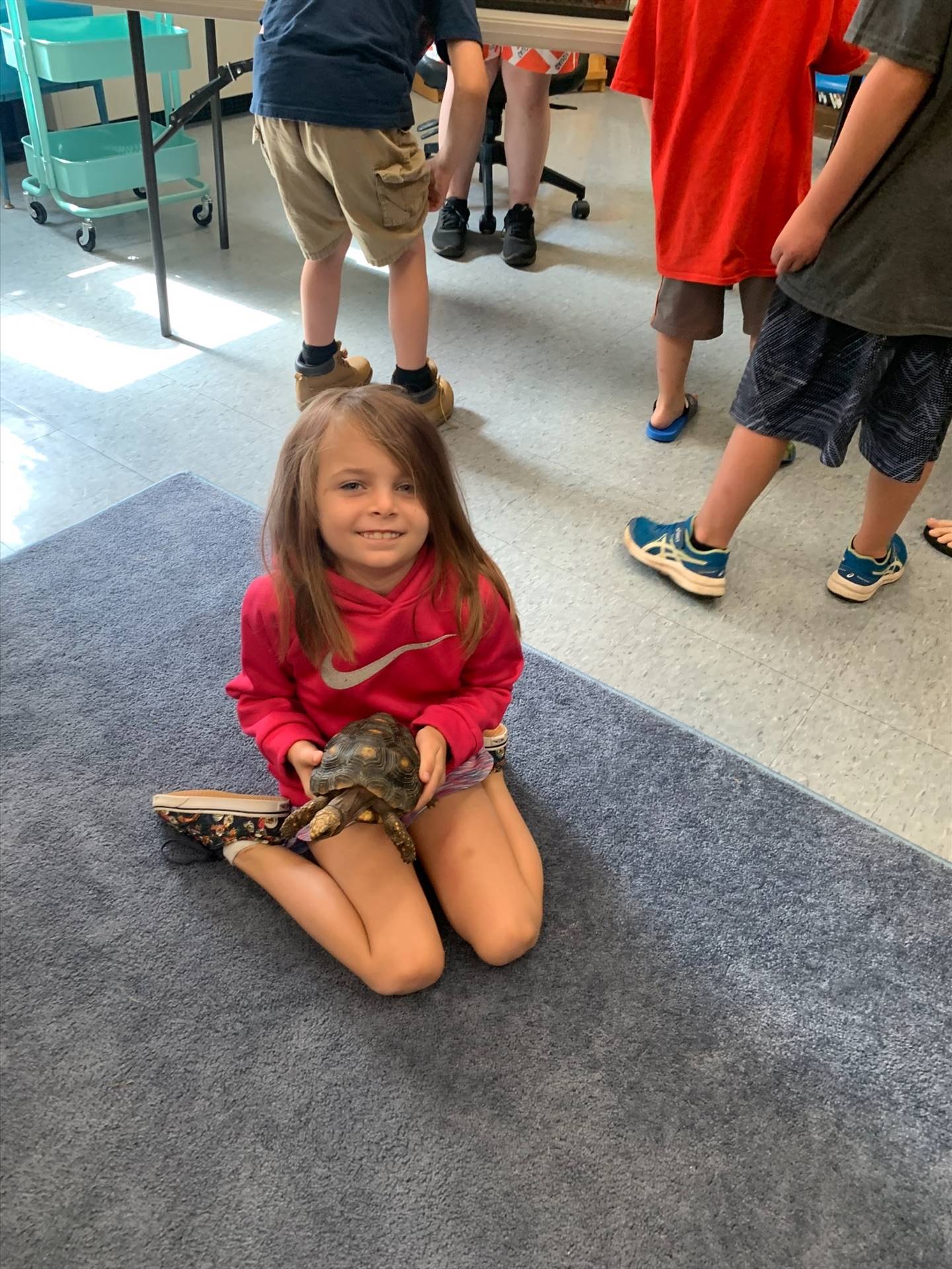 a student holds a tortoise