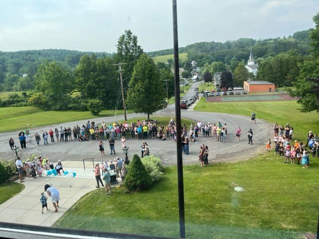 aerial view of pre k graduation looking down on circle with students and parents.