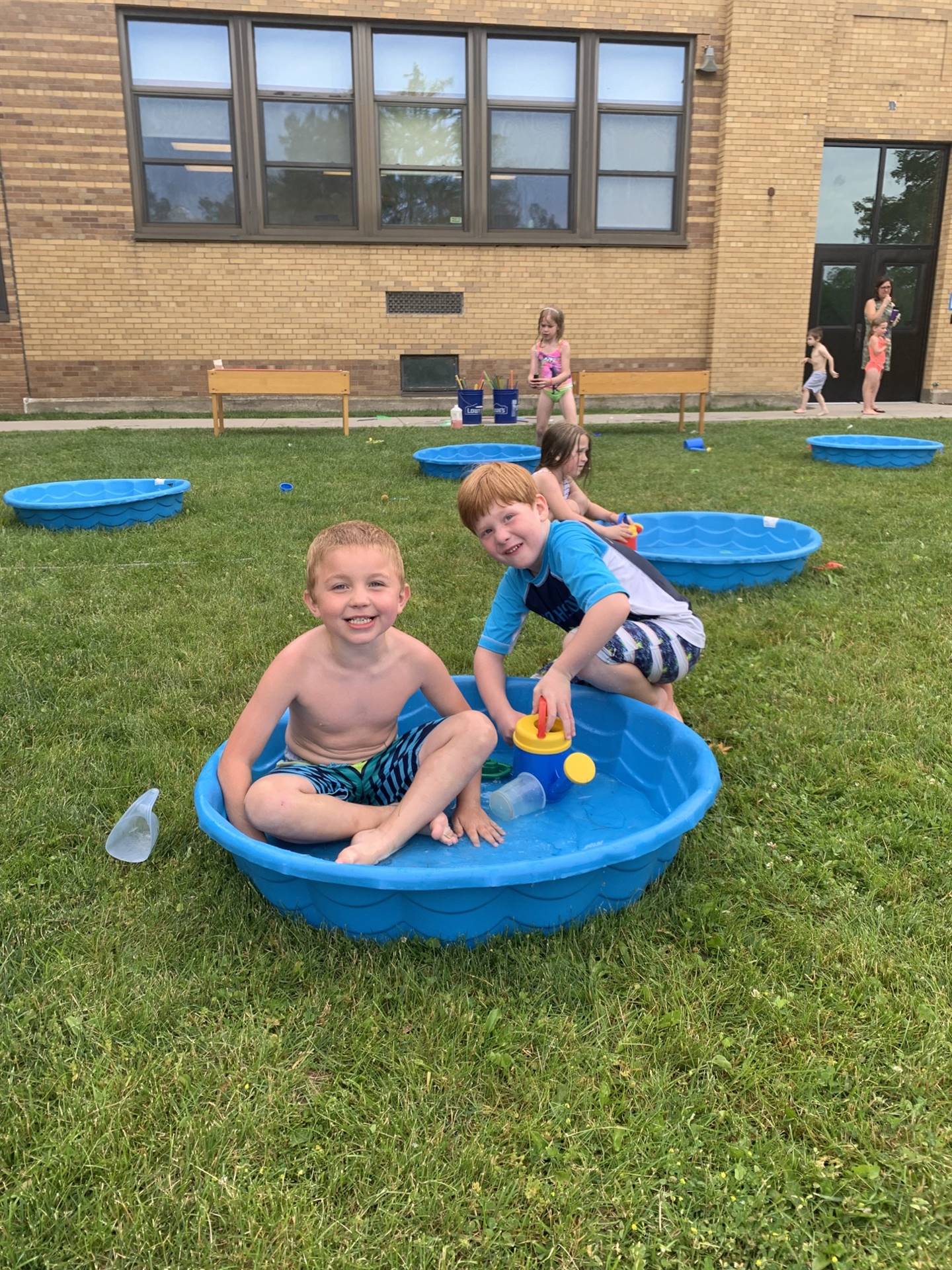 2 students playing in a wading pool