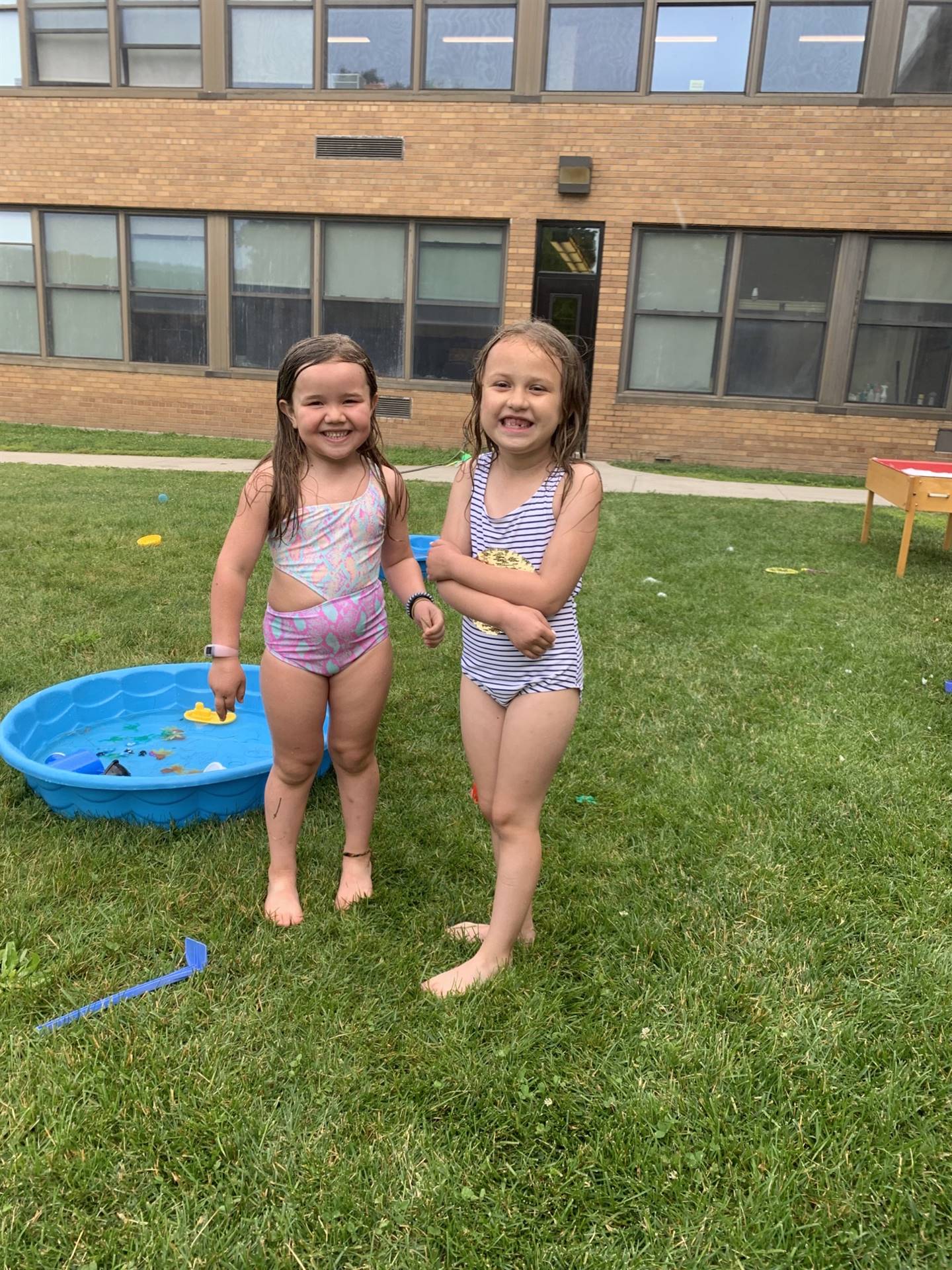 2 students by a wading pool