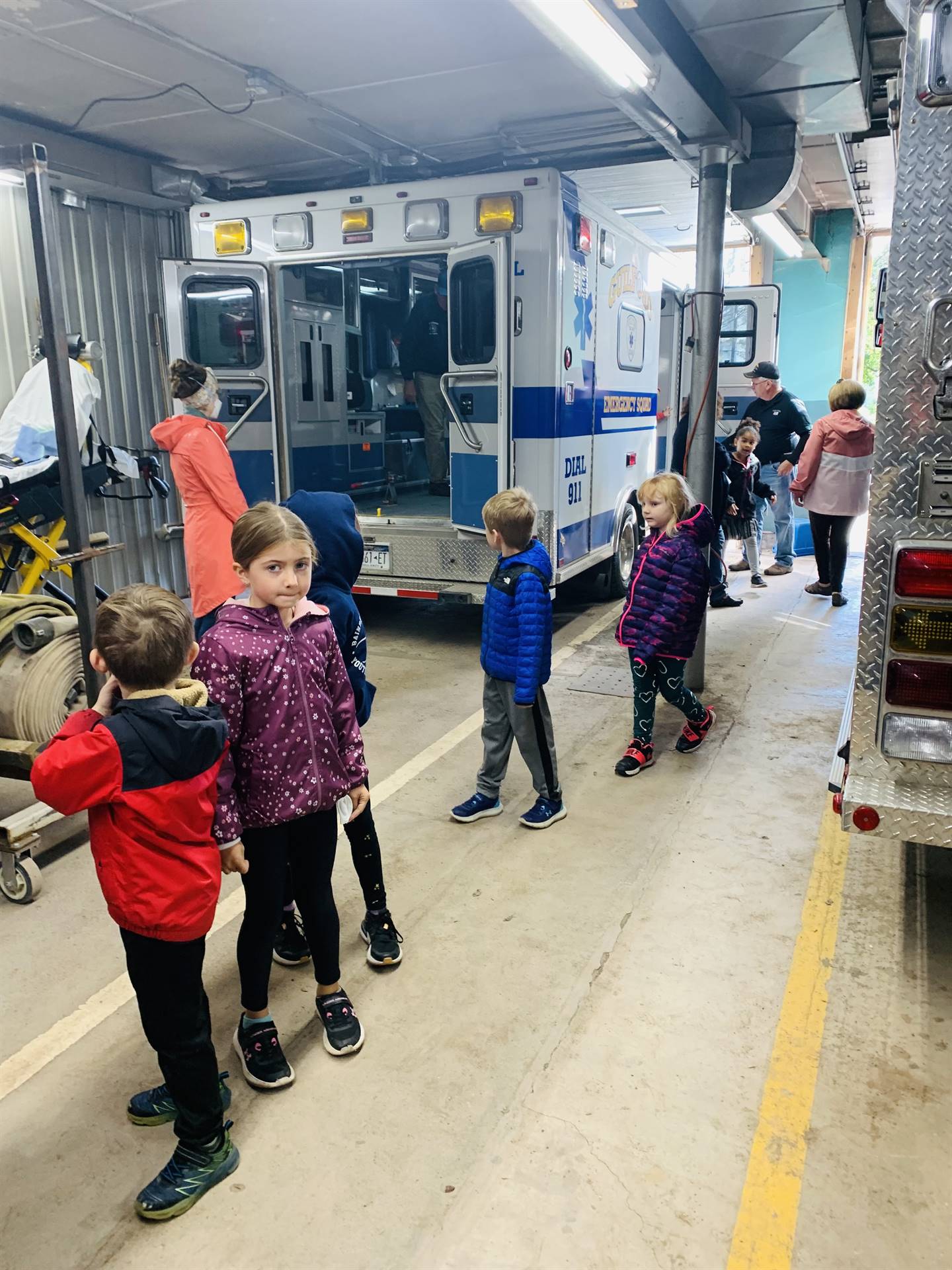 students walking through a fire station. 