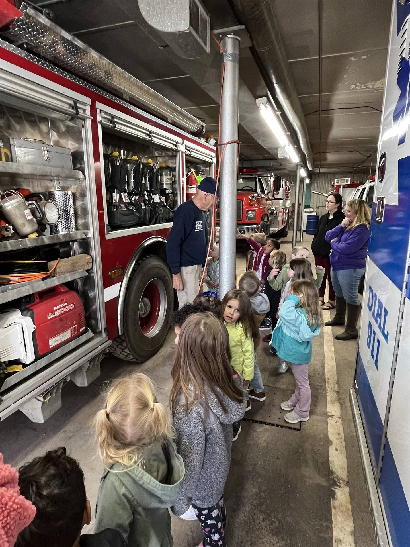 Firefighter tells students about the equipment found on a firetruck