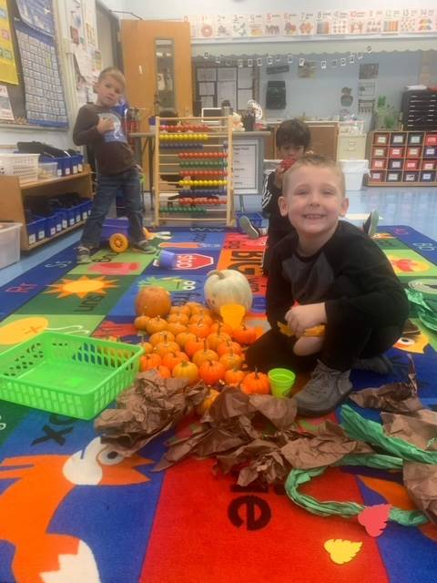 A student inside surrounded by pumpkins