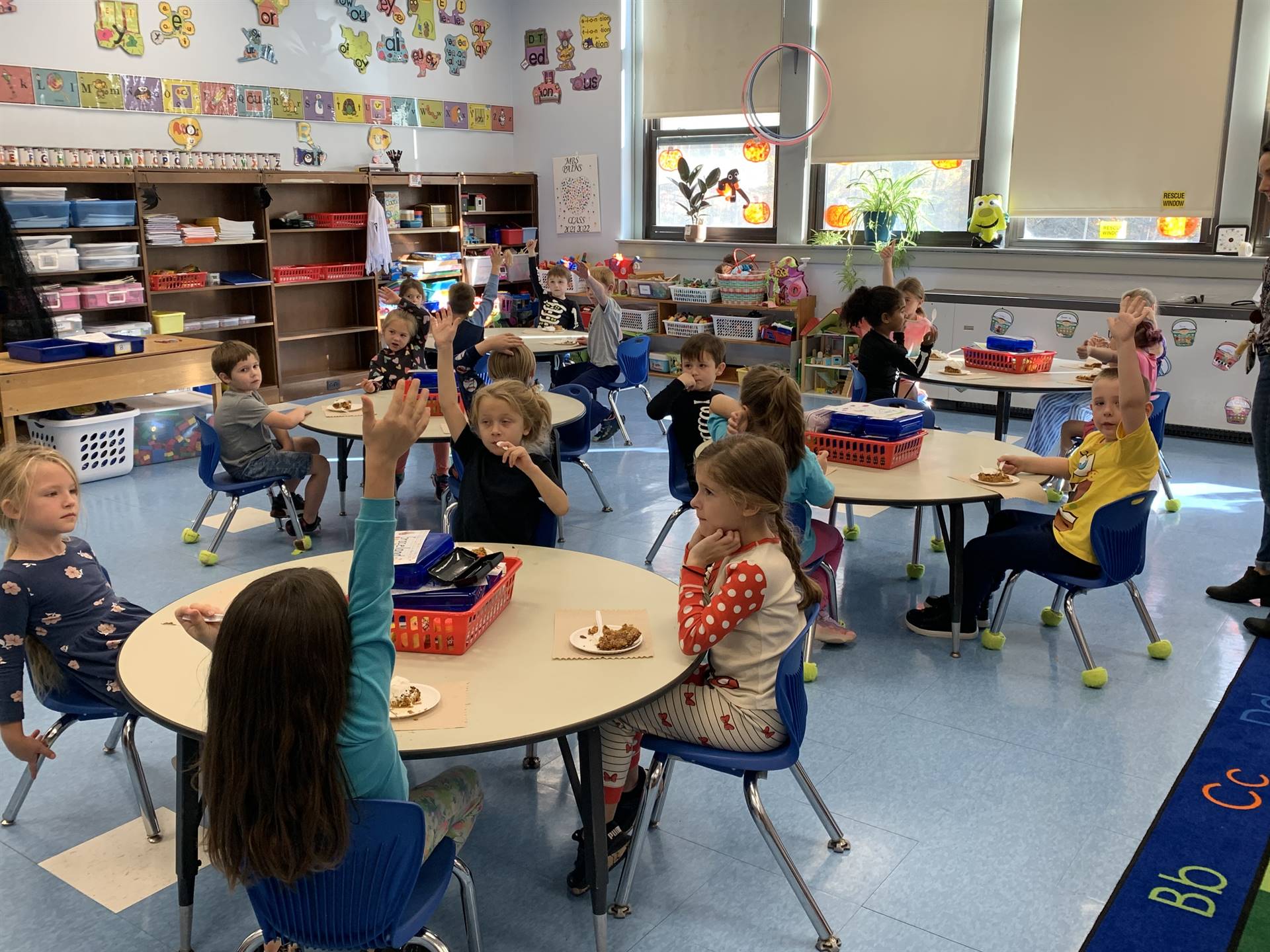 students at desks with pumpkin cake