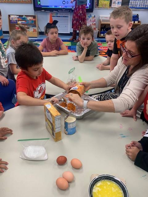 students at desks with ingredients for  pumpkin cake