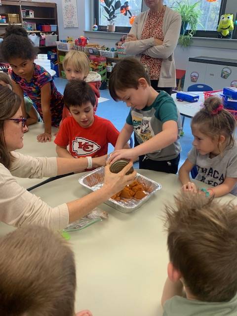 students dumping ingredients for pumpkin cake