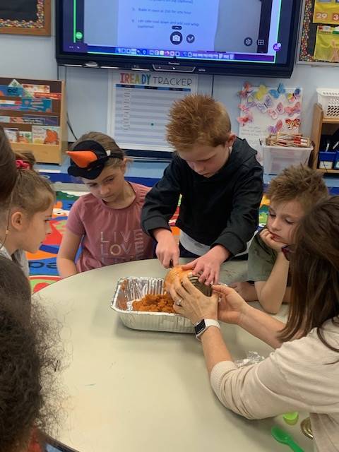 students dumping ingredients for pumpkin cake