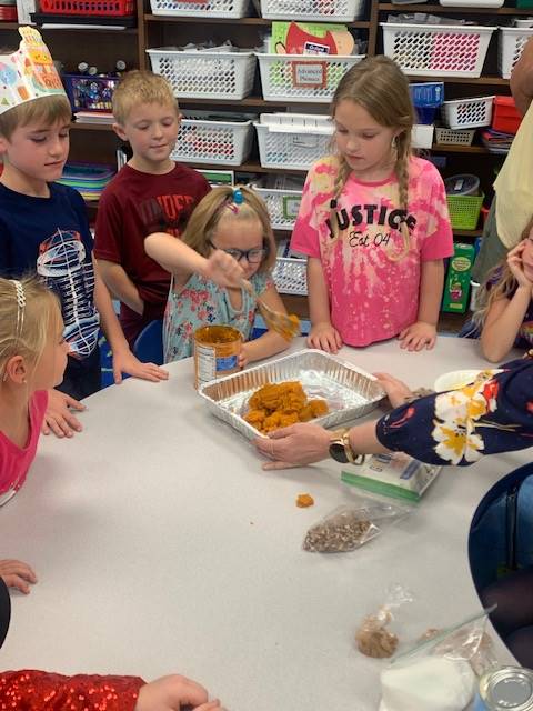 students dumping ingredients for pumpkin cake