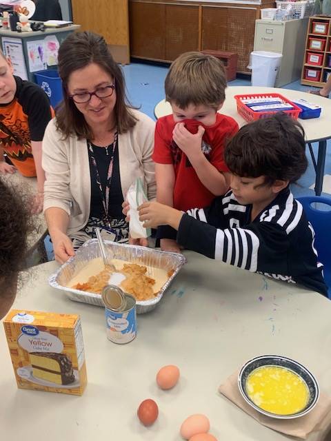 students dumping ingredients for pumpkin cake