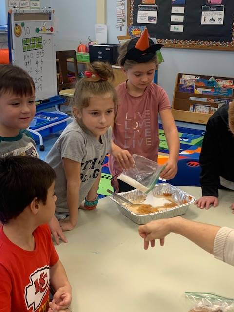 students dumping ingredients for pumpkin cake