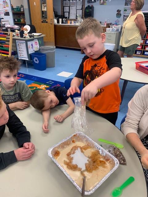 students dumping ingredients for pumpkin cake