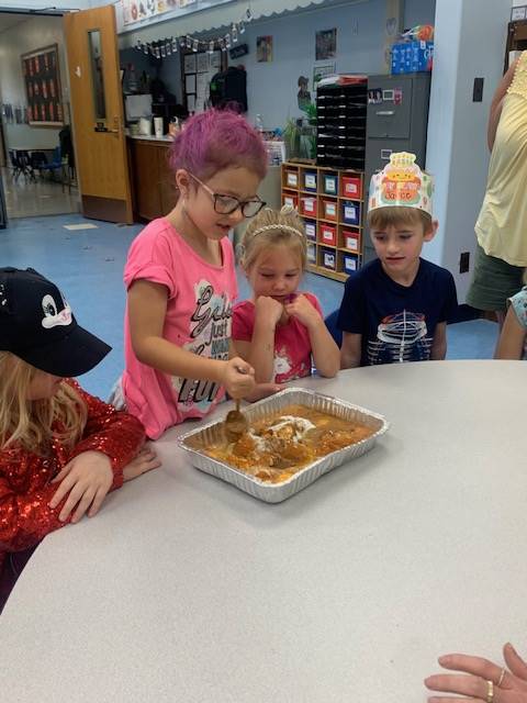 students dumping ingredients for pumpkin cake