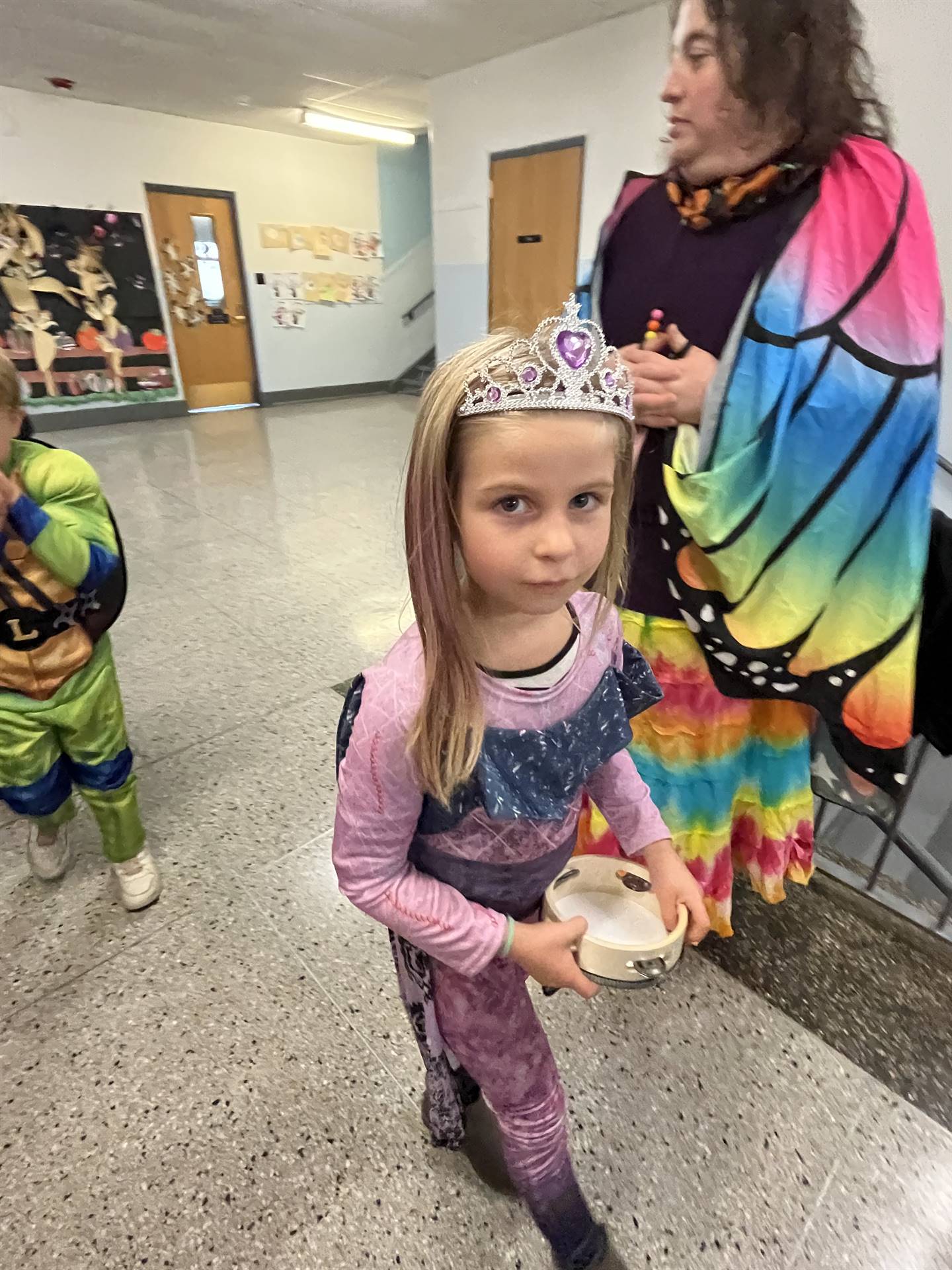 a teacher dressed as a butterfly and a student dressed as Muana 