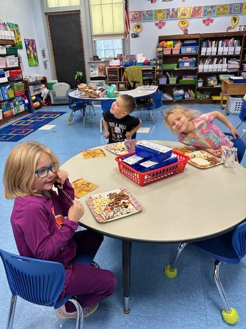 students at a table sampling different foods