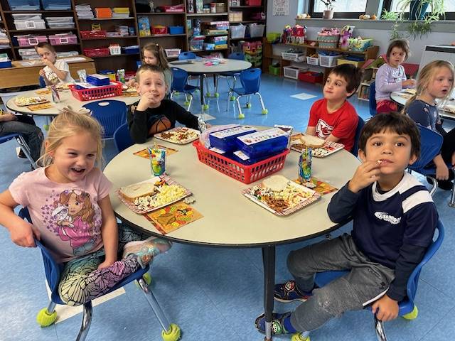 students at a table sampling different foods