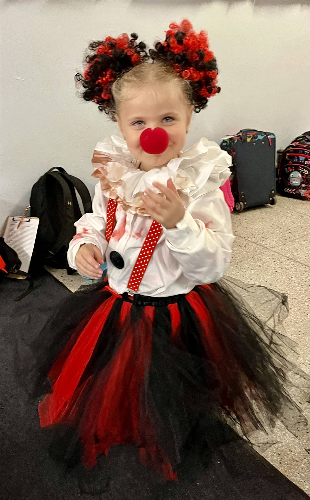 a student dressed as a clown with a big red nose!