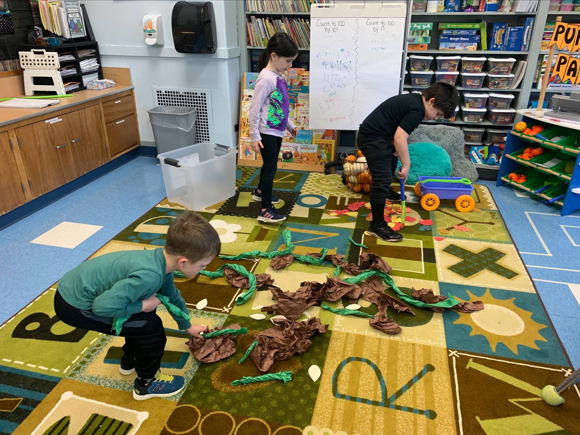 students create pumpkin vines out of paper and spread out on the floor