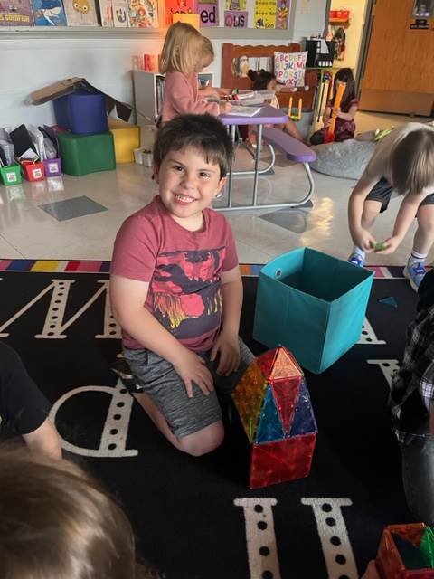 a student with magna tile tower