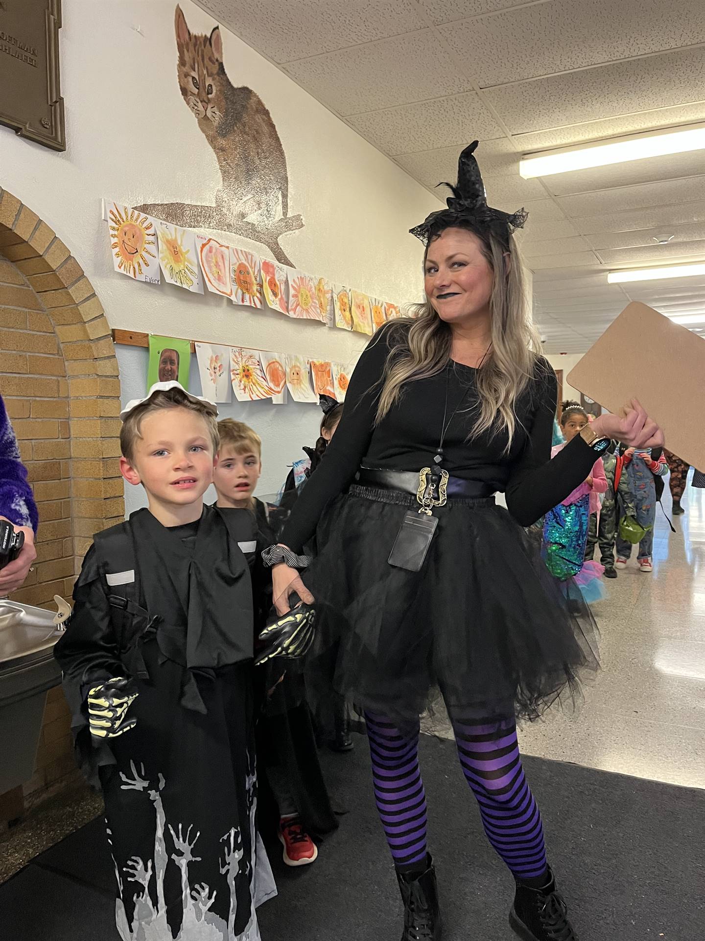 A teacher witch and a student dressed up.