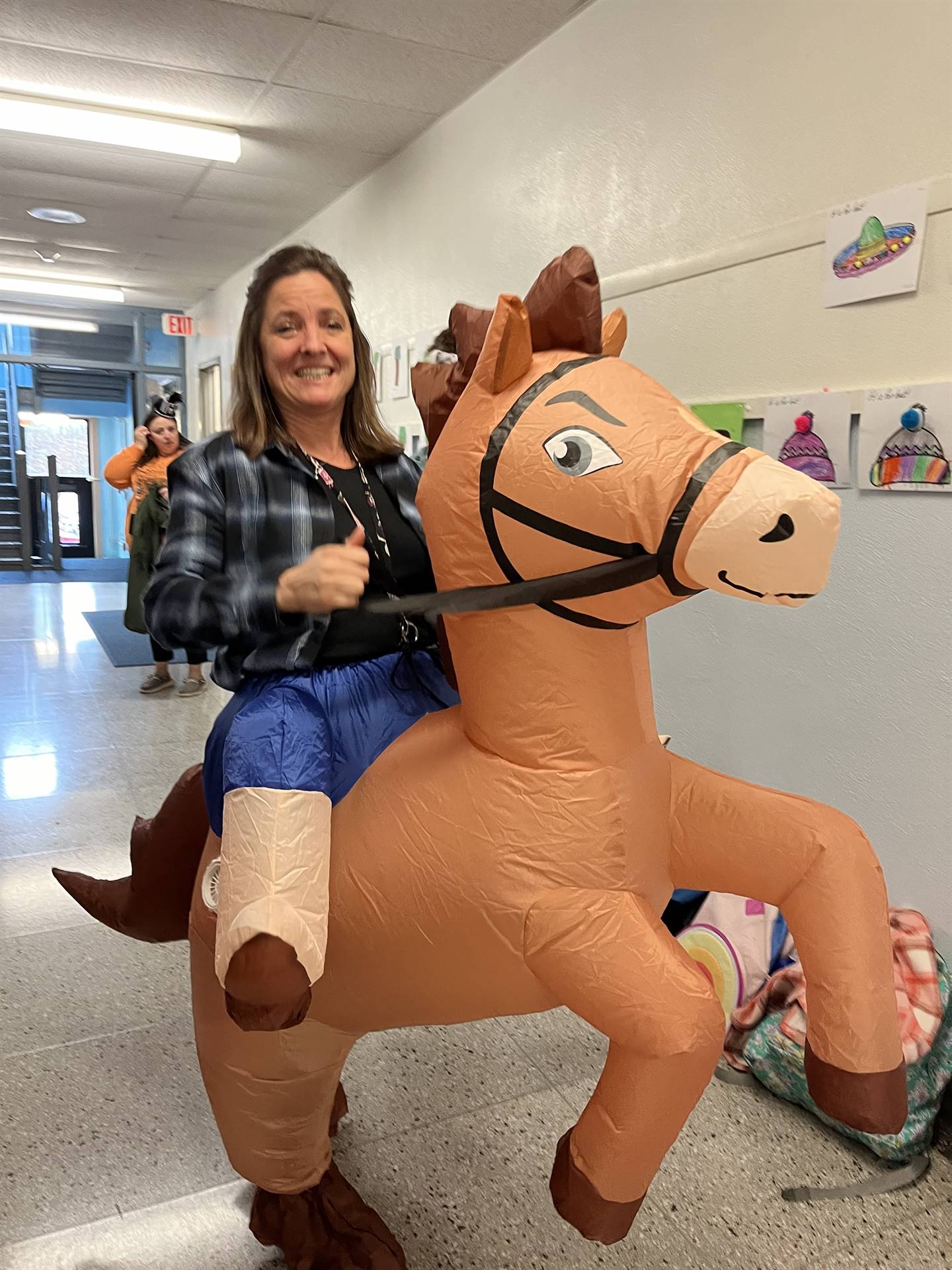 A teacher on a blow up horse for halloween