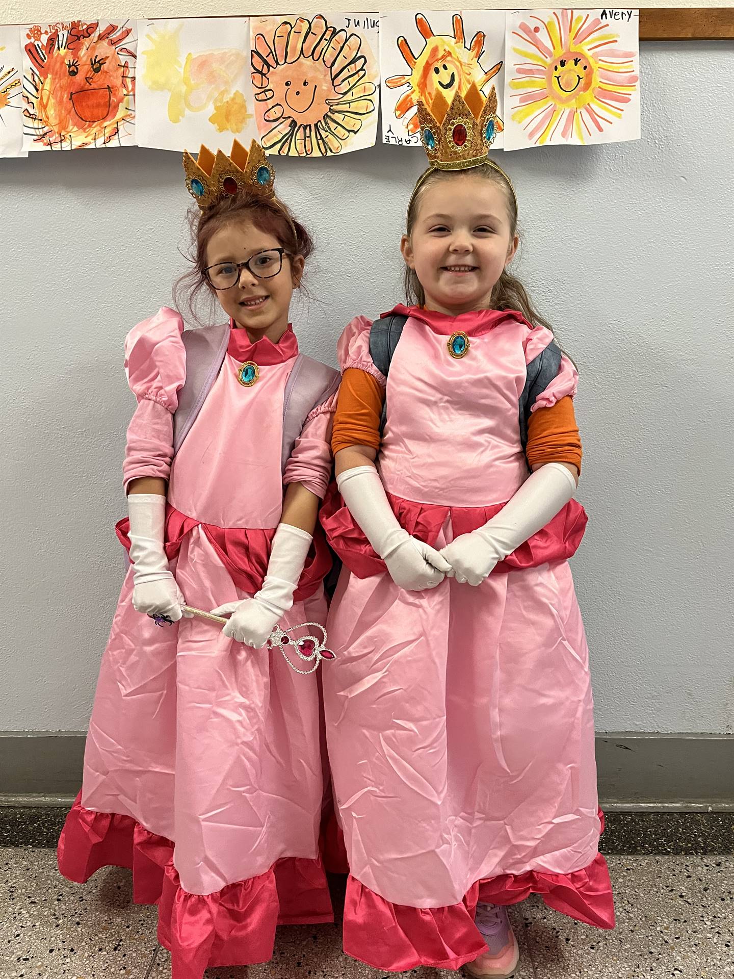 Twin princesses dressed in pink.