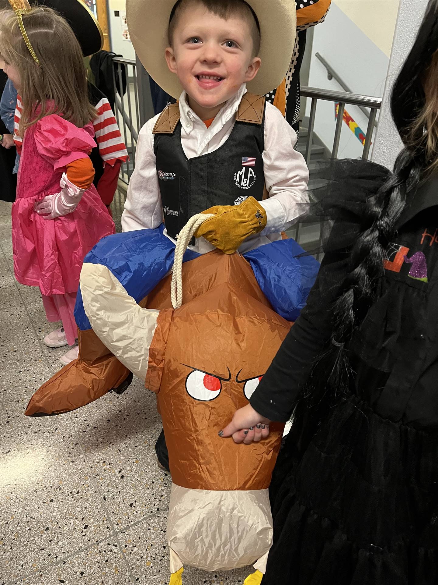 A student rides a blown up horse for halloween