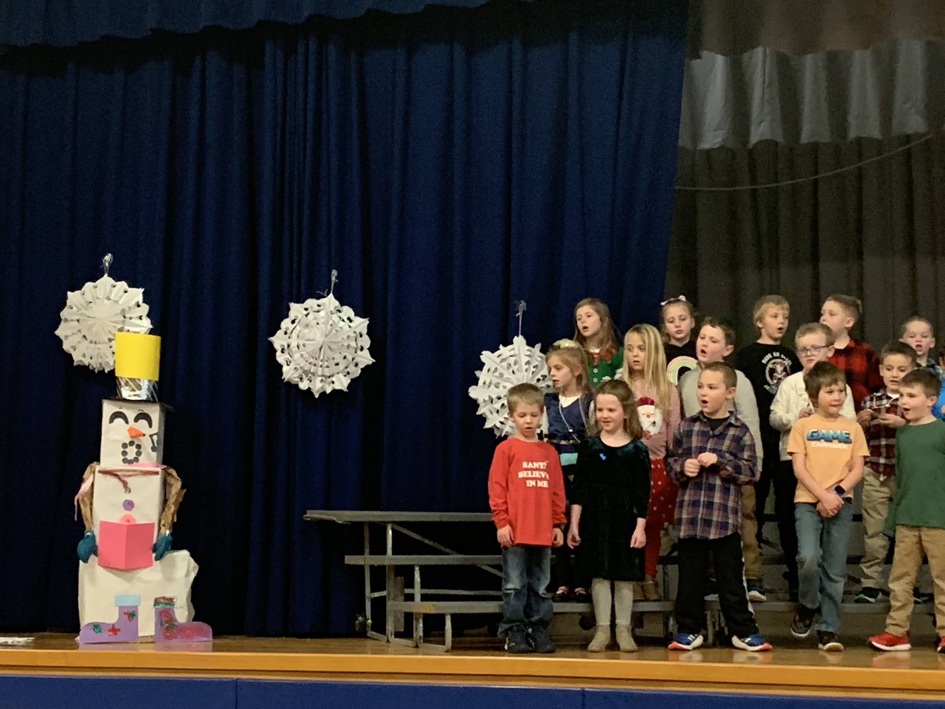 students singing with snowflake background
