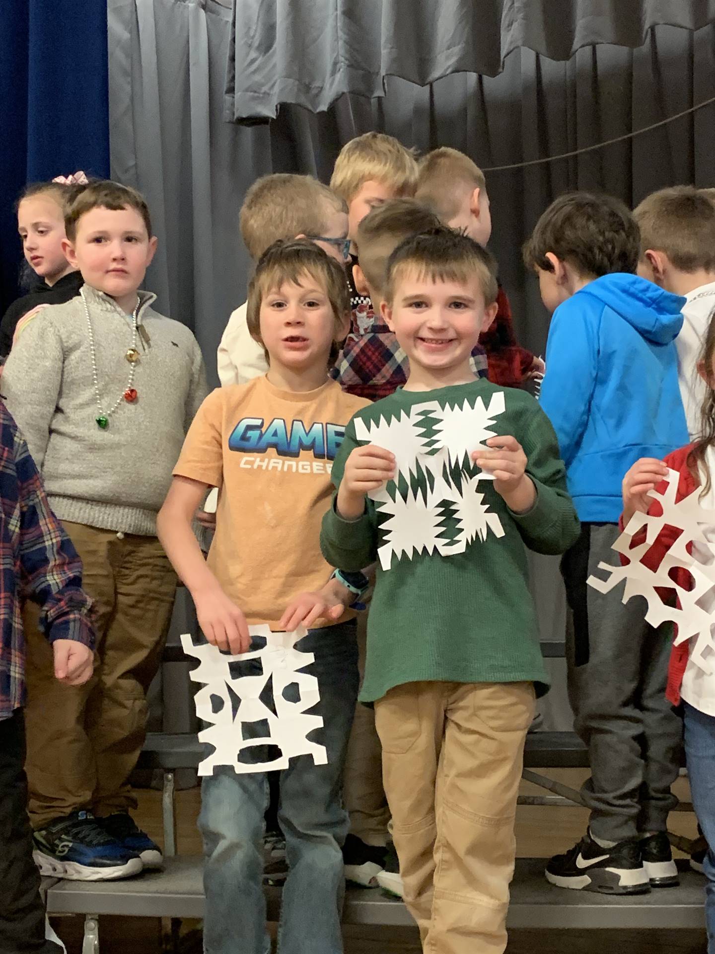  students holding snowflakes
