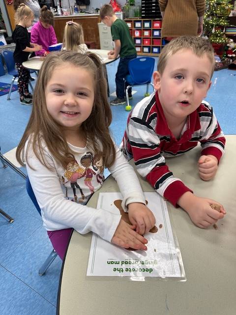 2 students create a play do  gingerbread friend .