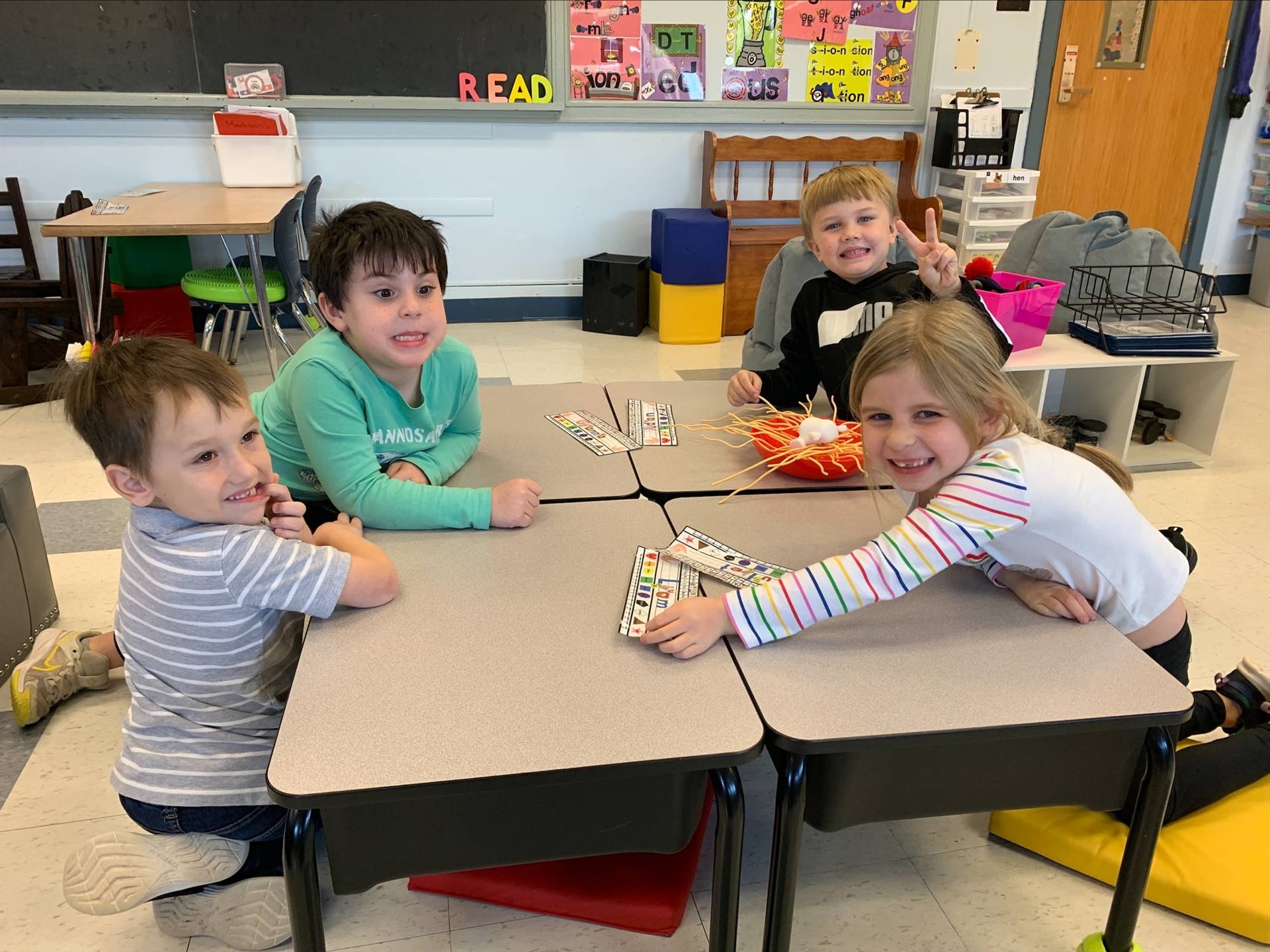 4 students playing at desks together